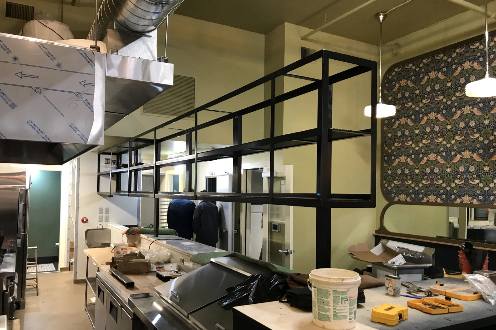 A custom-handcrafted black steel suspended gantry shelf system with an open-frame design. | Chip and Dale's Iron Works